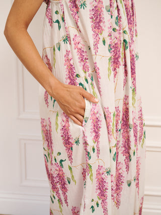 Model wears a nightie in wisteria print and with frills on the sleeves. the nightie has pockets. Close up. 