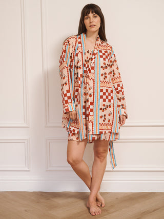 model wears a grandpa robe dressing gown with tomato print. close up. 