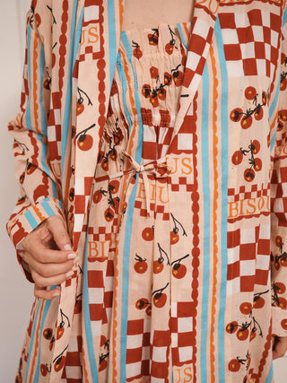 model wears a grandpa robe dressing gown with tomato print. close up of tie.