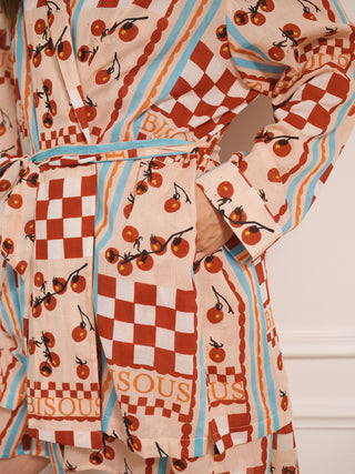 model wears a grandpa robe dressing gown with tomato print. close up of pocket.