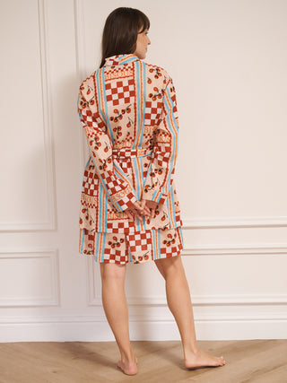 model wears a grandpa robe dressing gown with tomato print. back detail.