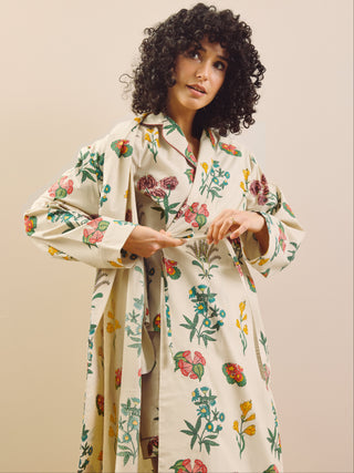 Woman wearing a floral patterned robe  against a beige background