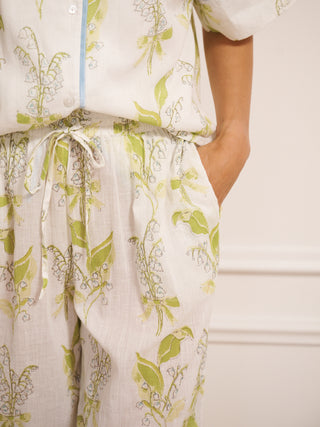 model wears lily of the valley print oversized pyjamas with contrast trim. detail shot