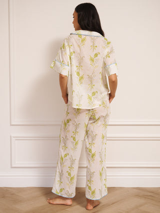 model wears lily of the valley print oversized pyjamas with contrast trim. Back shot. 