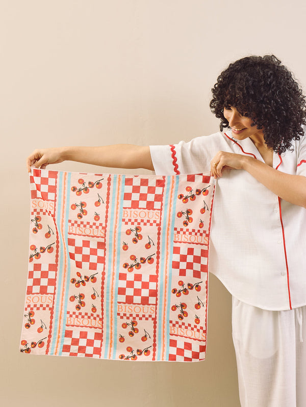 Person holding a patterned fabric against a beige background