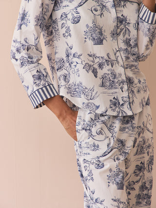 Floral pyjama set with striped cuffs and a pocket on a beige background