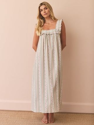 model wears and striped and floral night dress with frill square neck against a pink background