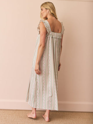 model wears and striped and floral night dress with frill square neck against a pink background