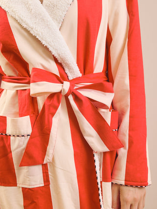 A close-up of a red and cream striped robe with a plush cream sherpa collar and a matching fabric tie belt, shown on a model.