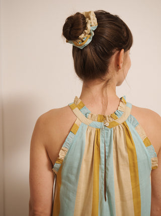 Cotton voile scrunchie in oatmeal rainbow stripe print worn on a bun, made from lightweight striped fabric.