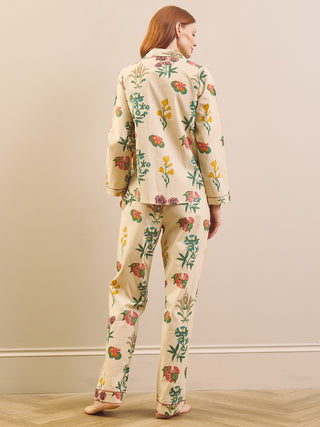 Model wears wallpaper floral print pyjamas on a neutral wall and wooden floor. Back Short
