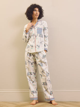 Woman wearing a navy and white Paris print pyjama set against a plain background