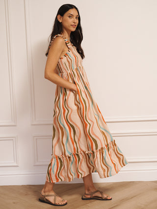 Model wearing Their Nibs linen mix ruched body midi dress in oatmeal rainbow waves print, side view