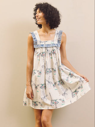 Woman wearing a Paris themed printed nightdress against a plain background 