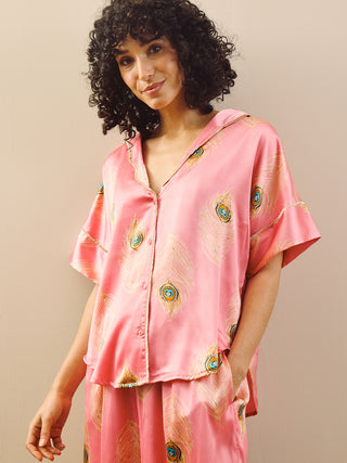 model wears pink long oversized pyjama set with peacock feather design