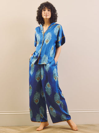 model wears blue long oversized pyjama set with peacock feather design