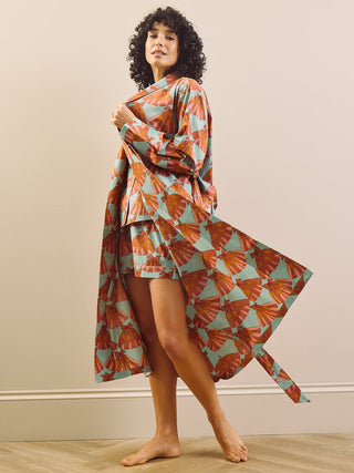 model wears a grandpa robe against a plain wall