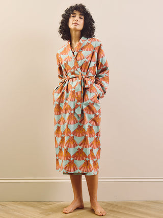 model wears a grandpa robe against a plain wall