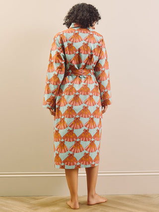 model wears a grandpa robe against a plain wall, back