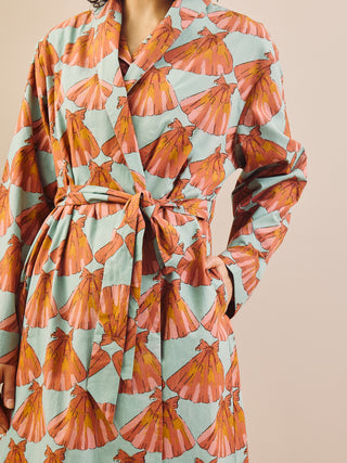 model wears a grandpa robe against a plain wall, close up