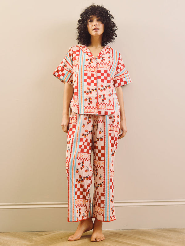 model wears red print long pyjama set with tomato design