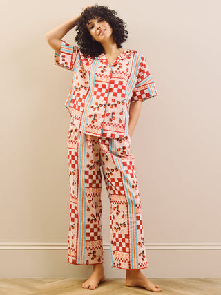 model wears red print long pyjama set with tomato design