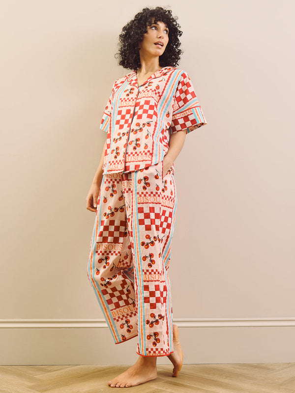 model wears red print long pyjama set with tomato design