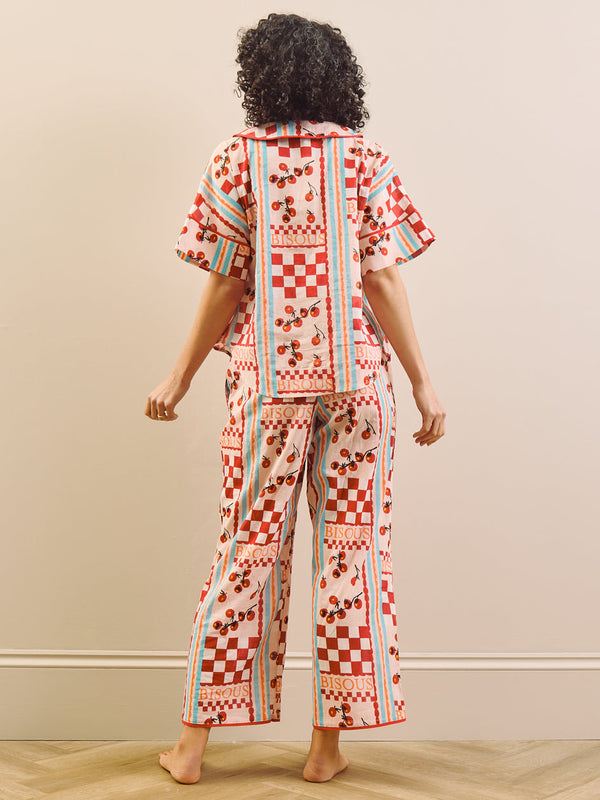 model wears red print long pyjama set with tomato design, back