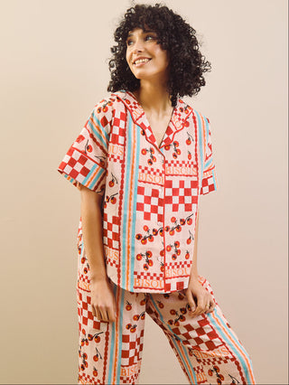 model wears red print long pyjama set with tomato design