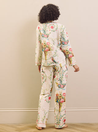 Person wearing a floral pyjama set against a plain background