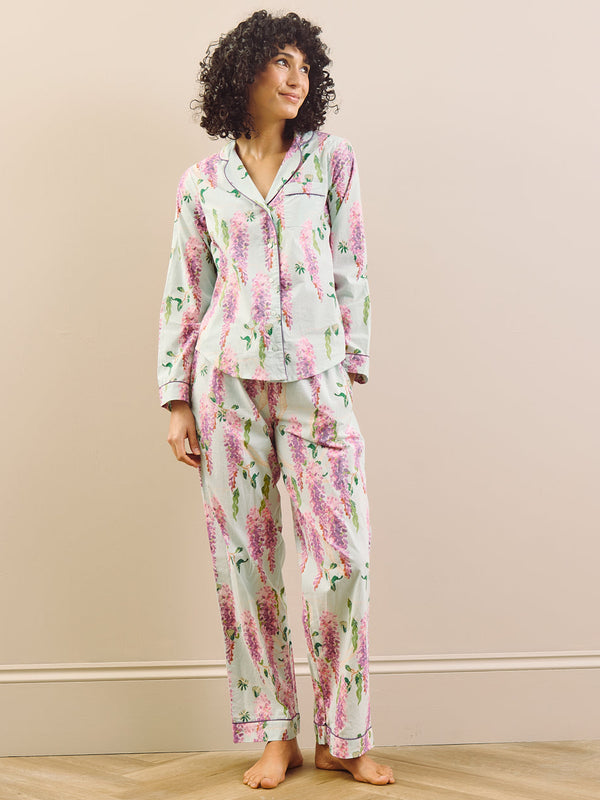 model wears long wisteria print pyjamas on beige background