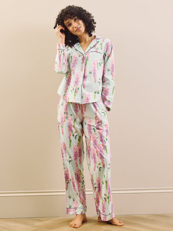model wears long wisteria print pyjamas on beige background