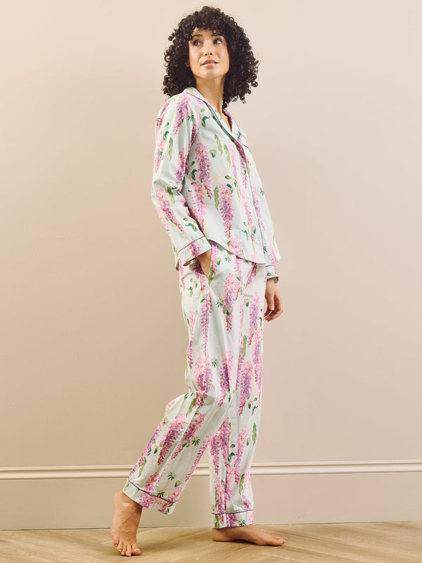 model wears long wisteria print pyjamas on beige background