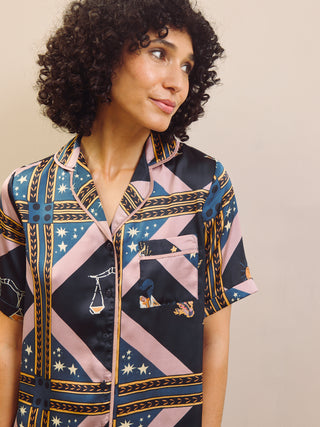 Woman wearing a patterned pyjama shirt with a neutral background
