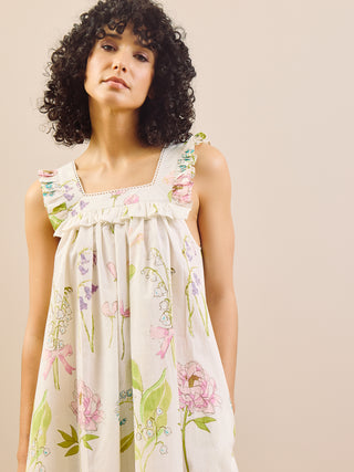 Woman wearing a floral night dress against a beige background