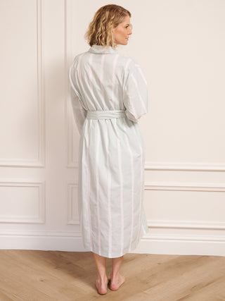 Model wearing women’s aqua brushed stripe cotton robe with tie waist and midi length, photographed barefoot in a neutral studio setting. Back Detail. 