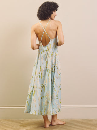 Woman wearing a floral night dress with a neutral background