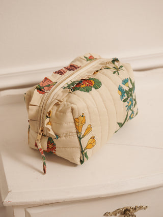 Floral-patterned cosmetic toiletry bag on a white surface