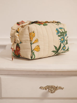 Floral-patterned cosmetic toiletry bag on a white surface