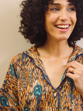 Woman wearing a feather patterned short pyjama set 