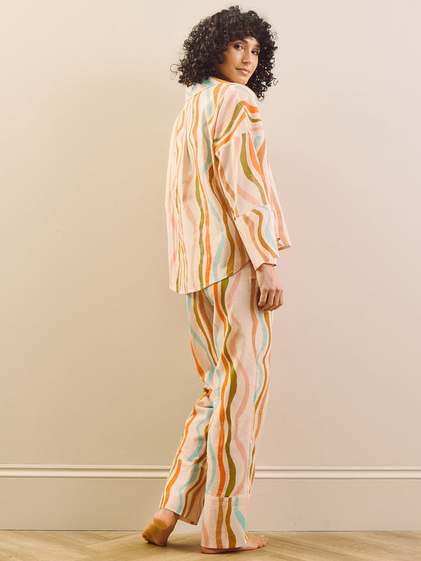 model wears a wavy stripe print pyjama set, back details