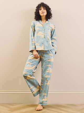 model wears light blue long traditional pyjama set with cloudy sky print