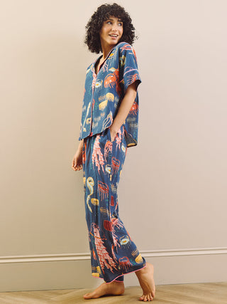 Model wears Ocean print pyjama set against a cream background