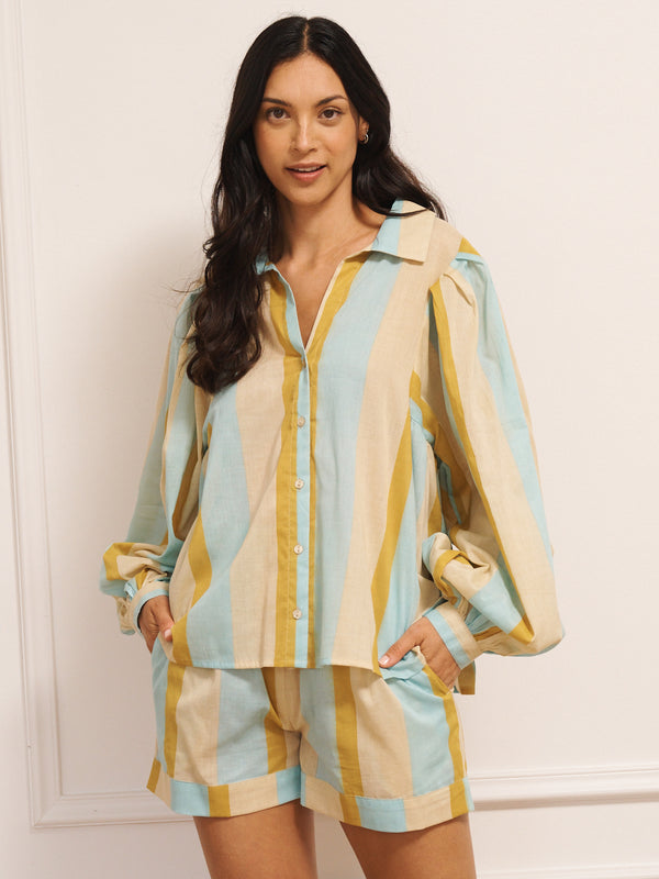 Model wearing a striped pyjama set against a plain background