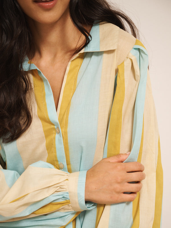 Model wearing a striped pyjama set against a plain background