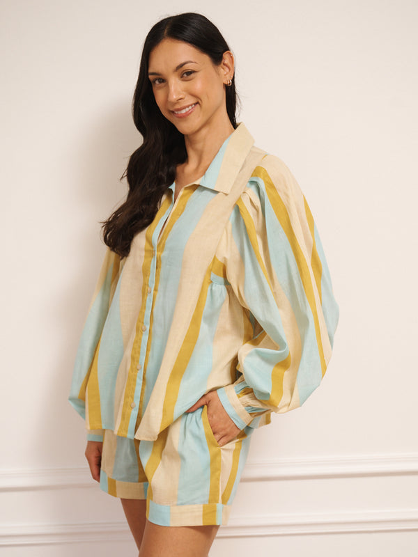 Model wearing a striped pyjama set against a plain background