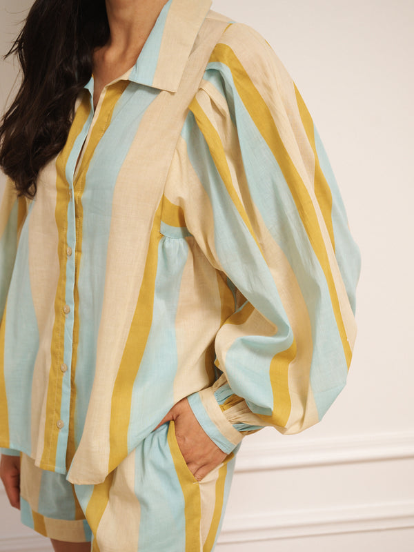 Model wearing a striped pyjama set against a plain background