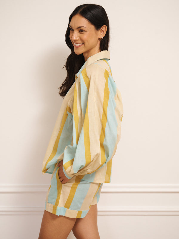 Model wearing a striped pyjama set against a plain background