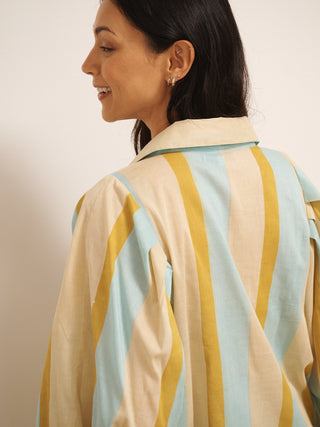 Model wearing a striped pyjama set against a plain background. Back detail