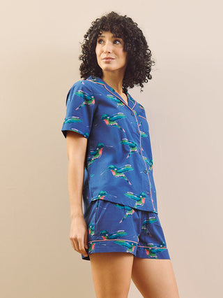 model wears a hummingbird print short pyjama set with a navy blue base 